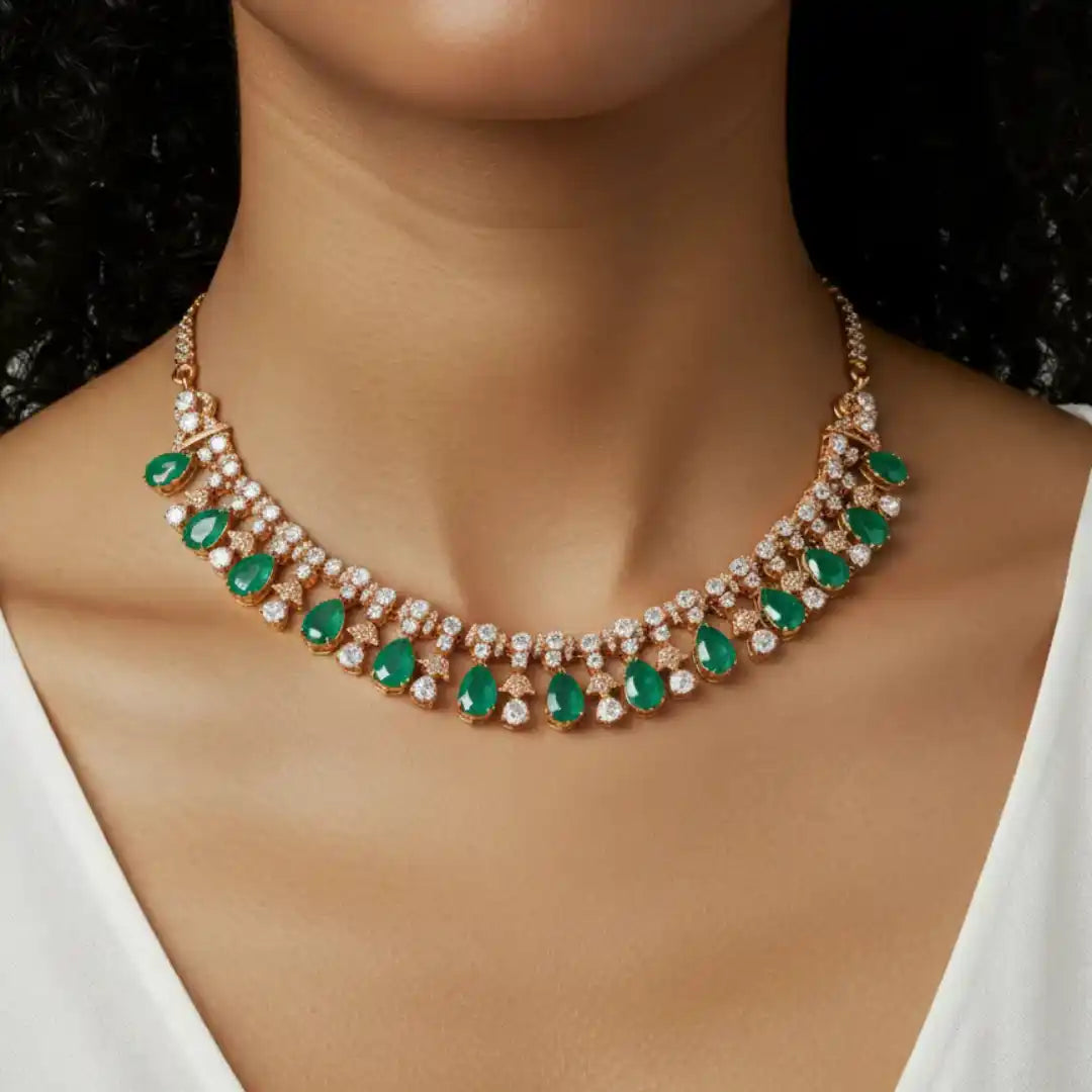 Elegant emerald and diamond necklace in rose gold, showcasing luxury jewelry design with green gemstones and sparkling accents.