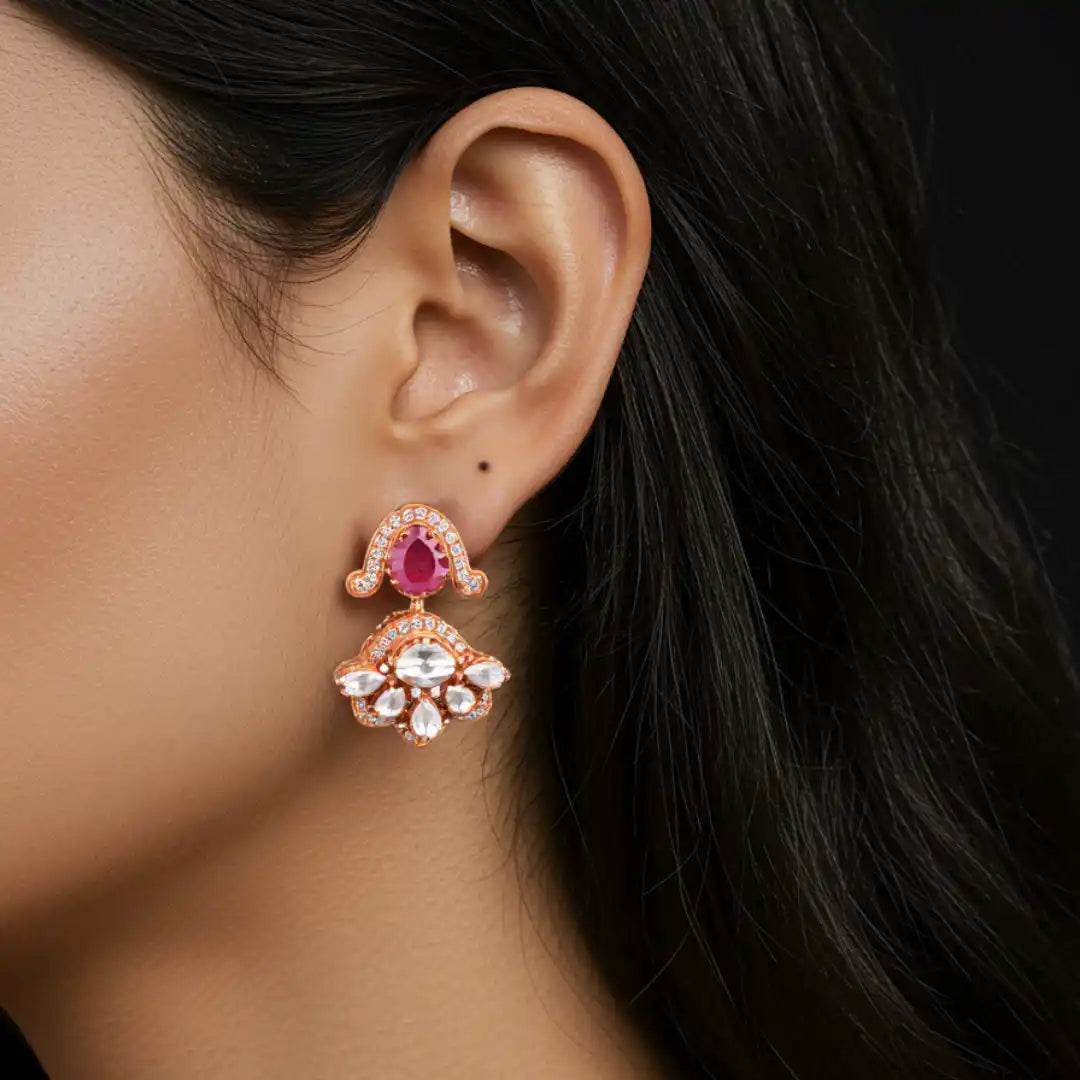 Elegant rose gold earring with ruby and diamond accents, showcasing intricate floral design for women.