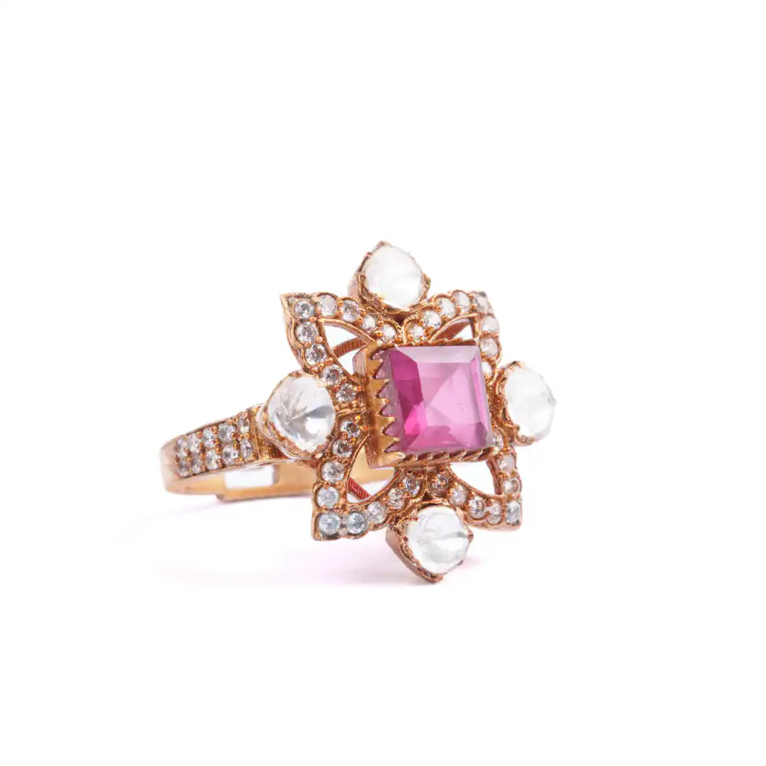 Elegant rose gold ring with pink square gemstone, white teardrop accents, and diamond-like pavé detailing.