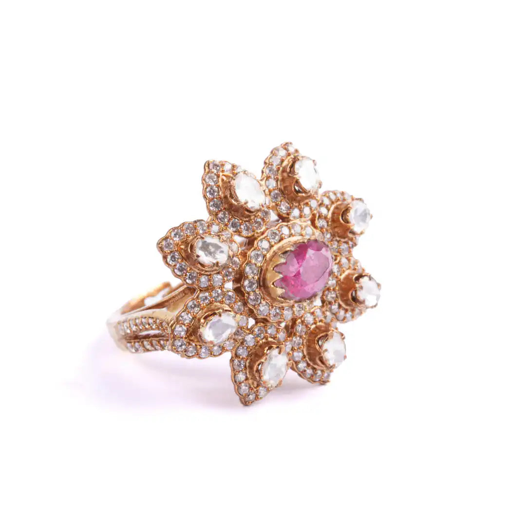 Floral gold ring with pink gemstone and diamond accents, elegant silver jewelry design