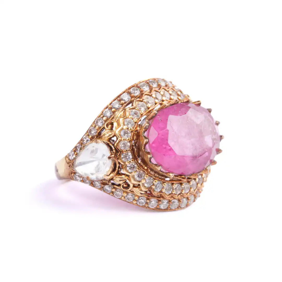 Elegant gold ring with pink gemstone and diamond accents, intricate filigree design