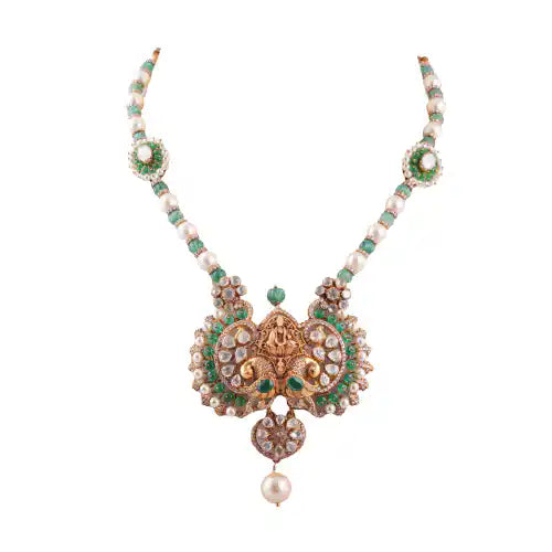 Elegant silver necklace with emerald and pearl accents, featuring intricate Ganesha-inspired design