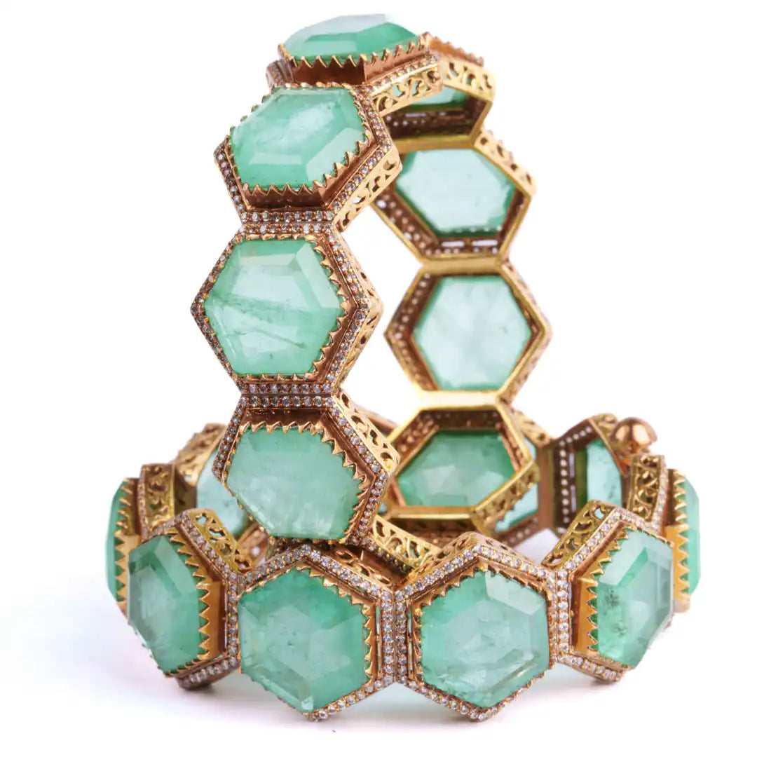 Luxury emerald hexagon bangle with diamond accents and gold filigree detailing