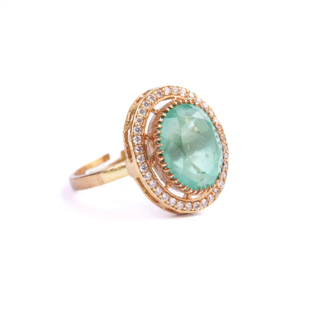 Elegant gold ring with oval emerald and diamond halo, perfect for luxury jewelry lovers.