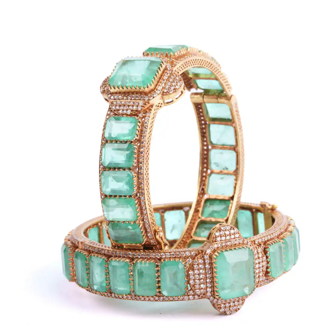 Luxury emerald and diamond bangle set in gold-tone metal, elegant statement jewelry for women