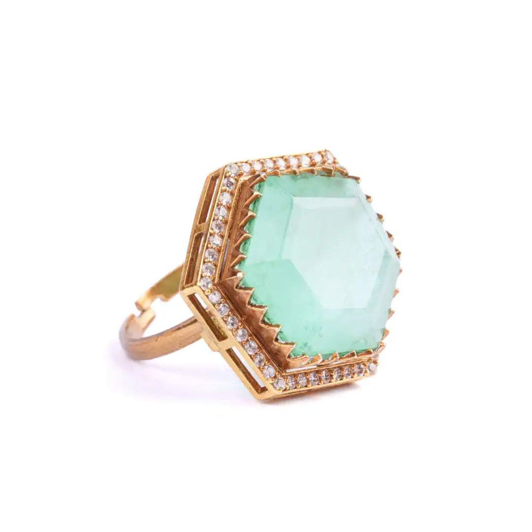 Gold ring with large green gemstone and diamond accents, elegant hexagonal design