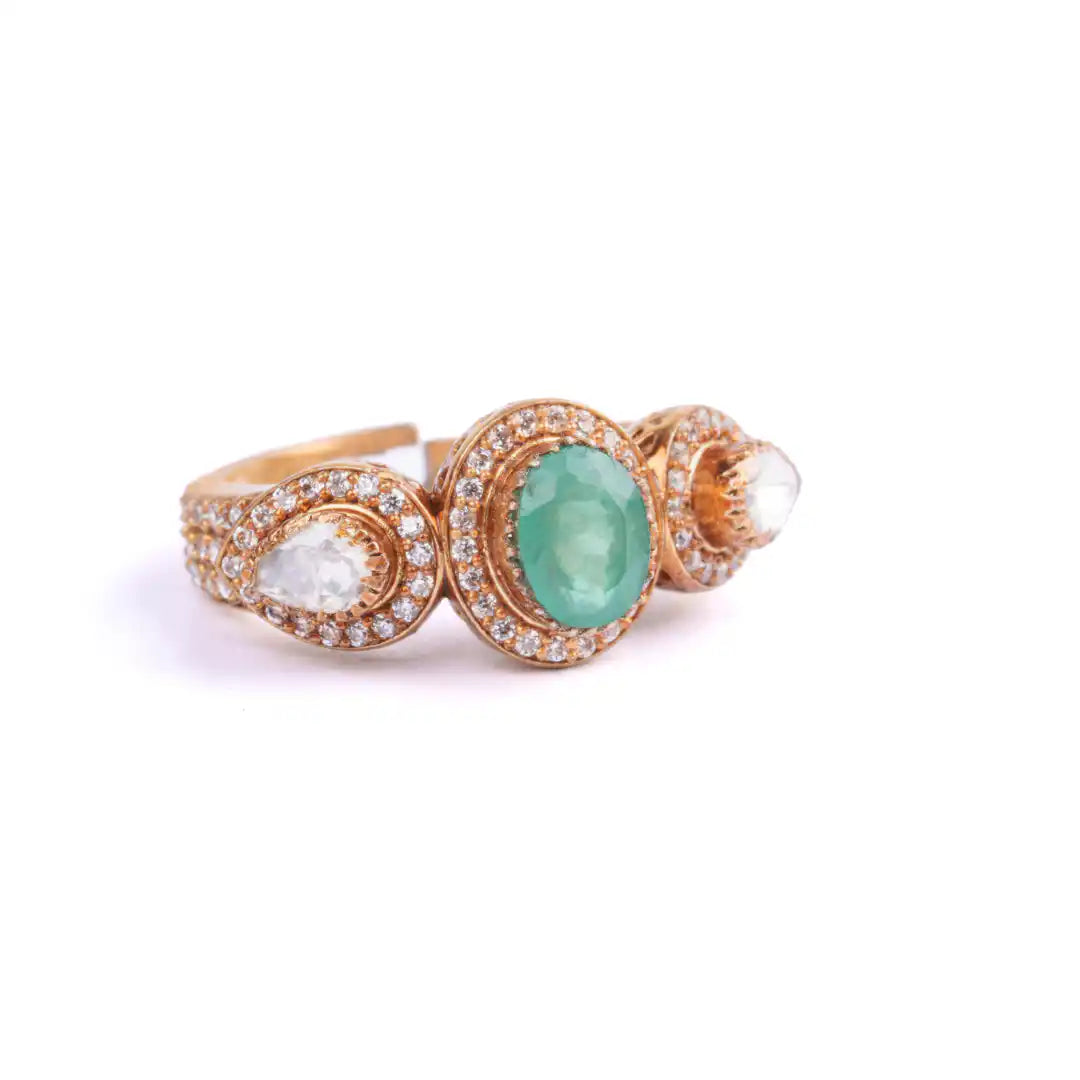 Elegant rose gold ring with emerald and diamond accents, perfect for luxury jewelry lovers