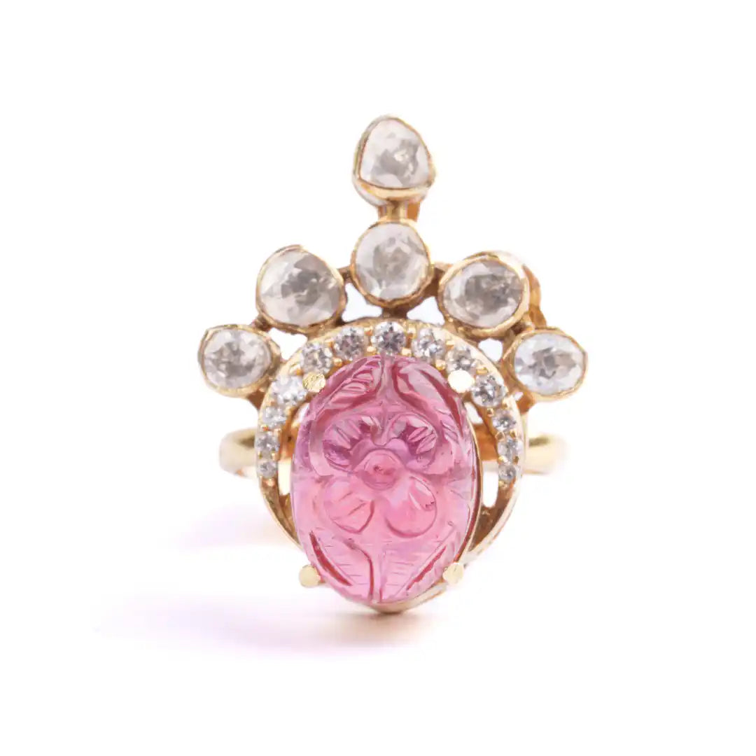 Pink carved gemstone ring with diamond accents in gold setting