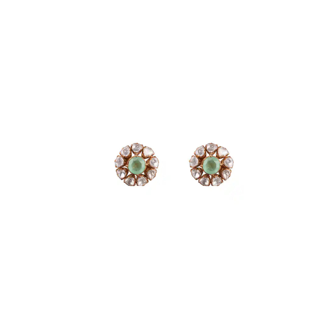 Elegant floral stud earrings with green gemstone center and diamond accents