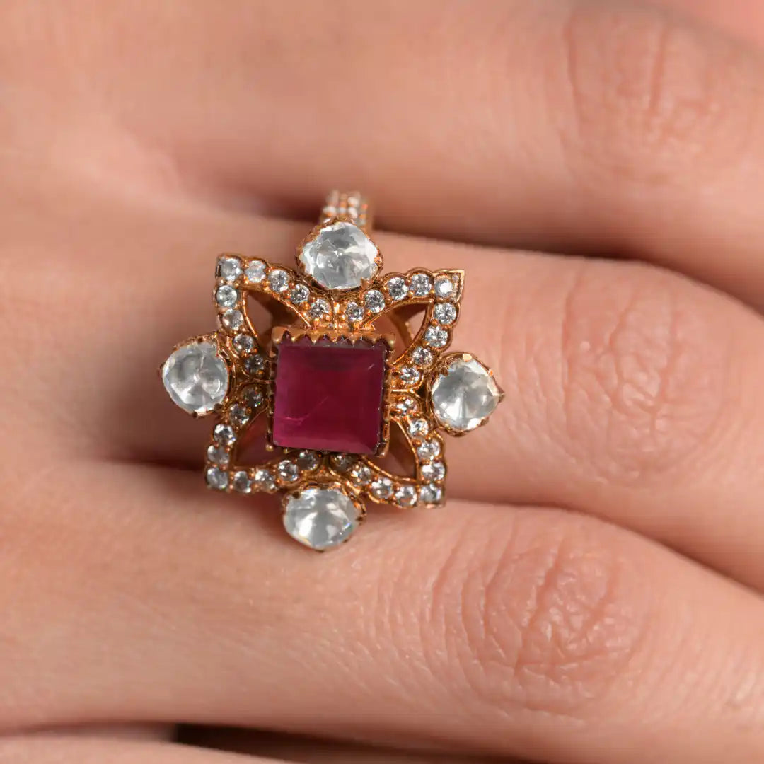 Elegant ruby and diamond ring with intricate gold setting, showcasing luxury jewelry design.