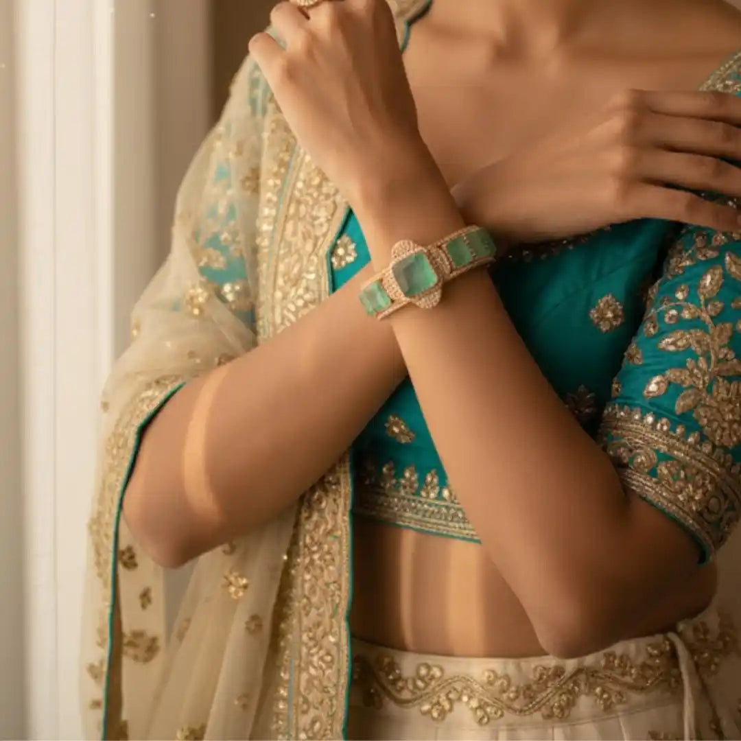 Elegant silver bracelet with green gemstones, worn with traditional Indian attire