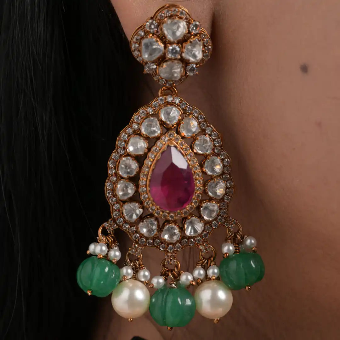Elegant gold earring with ruby, pearls, and green beads, perfect for traditional wear.