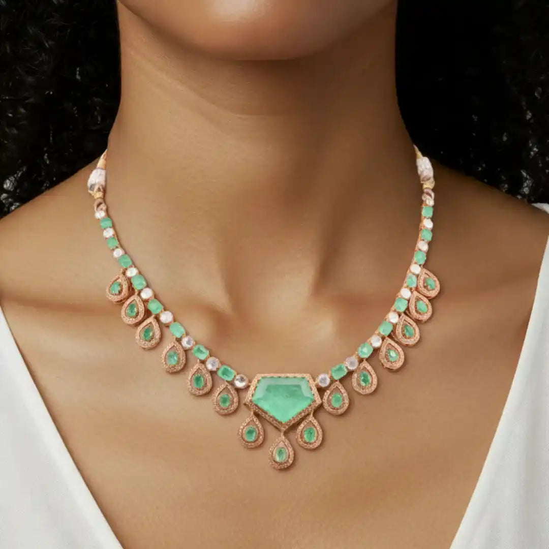 Elegant emerald and diamond necklace with rose gold pendant, perfect for luxury occasions.