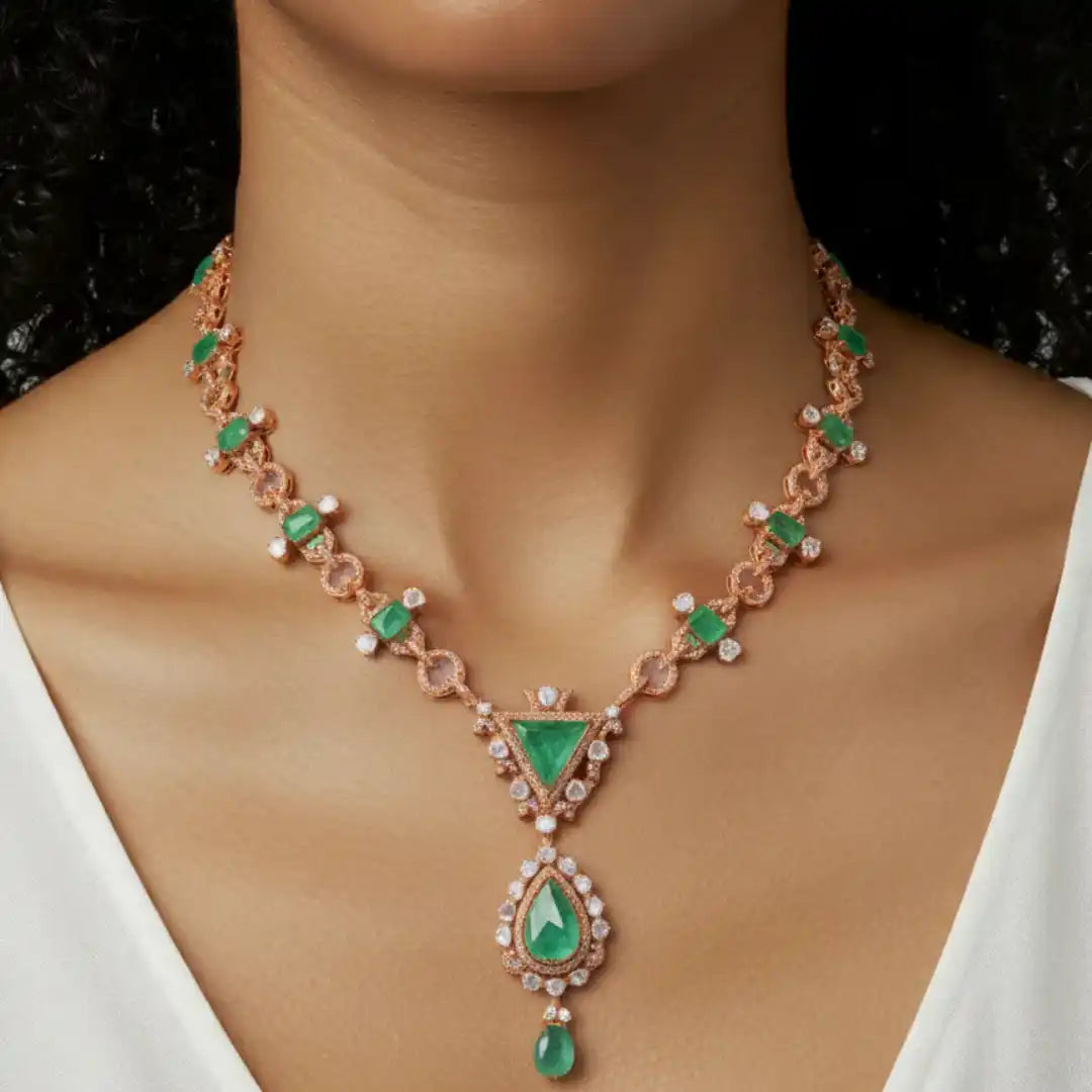 Elegant rose gold necklace with emerald and diamond accents, showcasing luxury jewelry design.