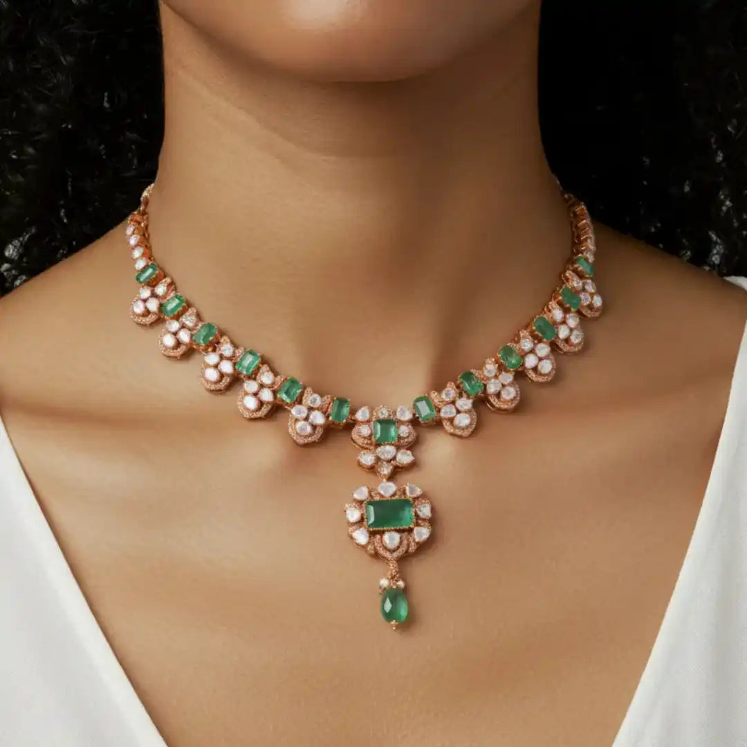 Elegant emerald and diamond necklace with rose gold setting, showcasing luxury jewelry design.