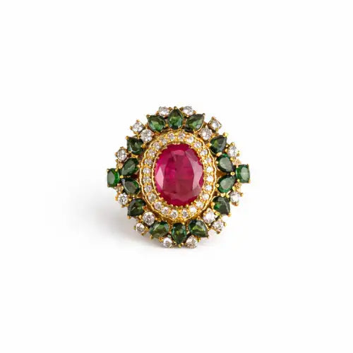 Elegant gold ring with oval ruby center, surrounded by emerald and diamond accents, showcasing fine craftsmanship.