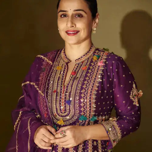 Woman in purple embroidered kurta with silver jewelry, showcasing traditional Indian attire and elegance