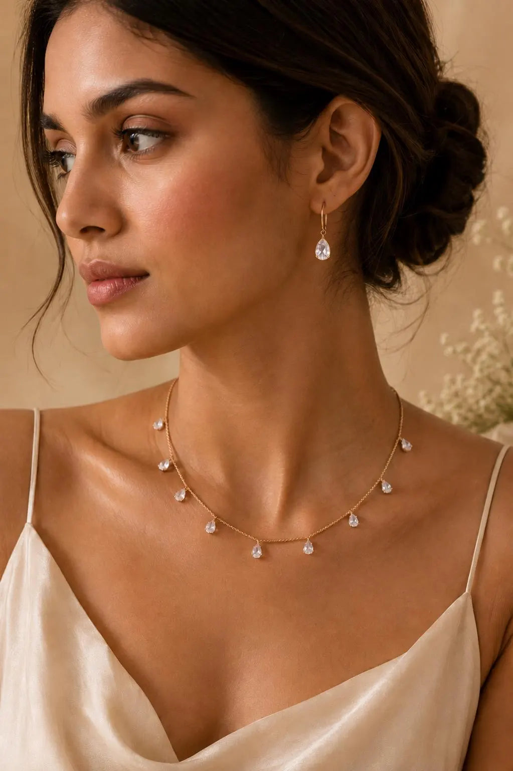 Gajaah elegant teardrop crystal gold necklace and matching earrings set with sparkling crystal accents and intricate gold details.